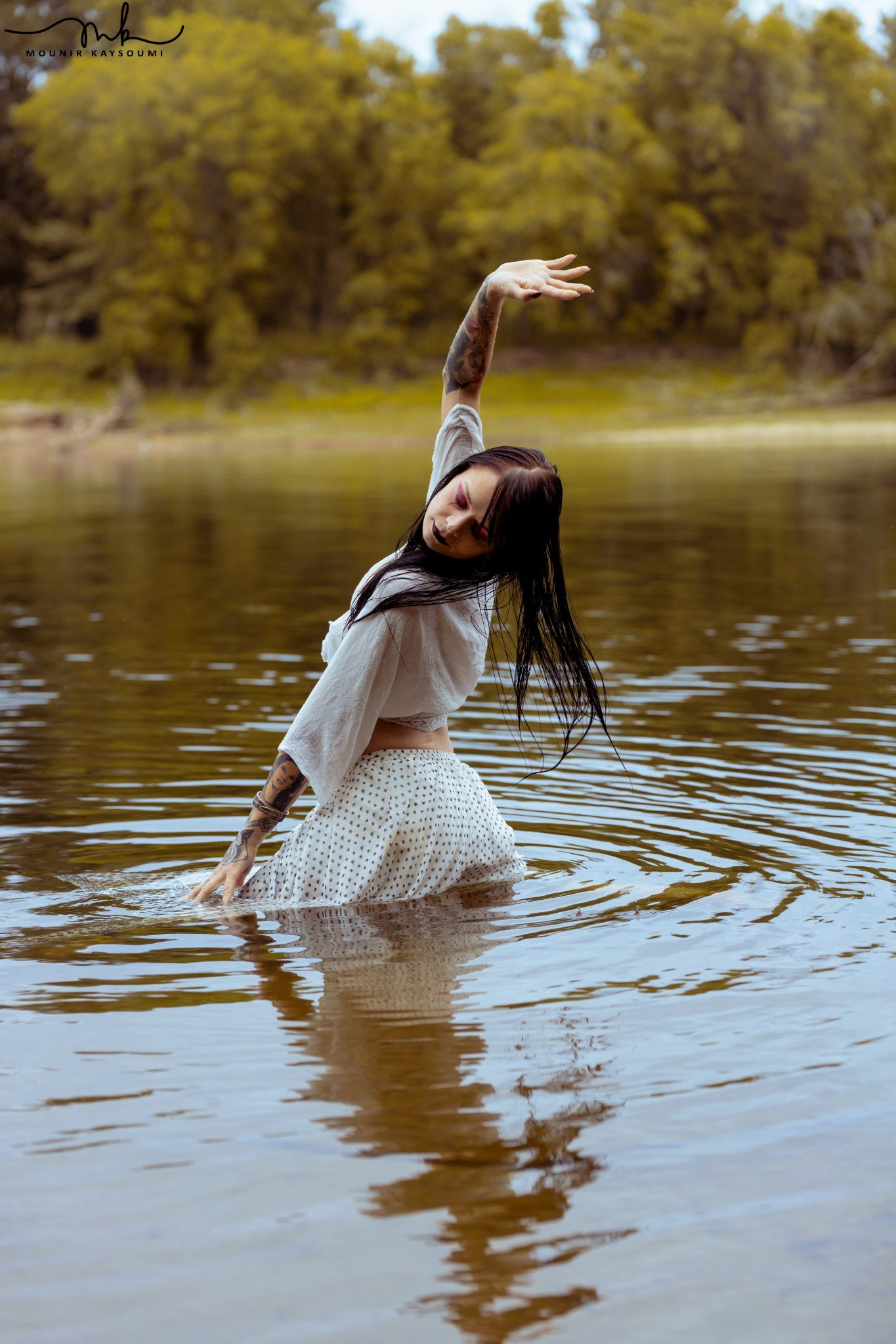 Woman in white standing in water