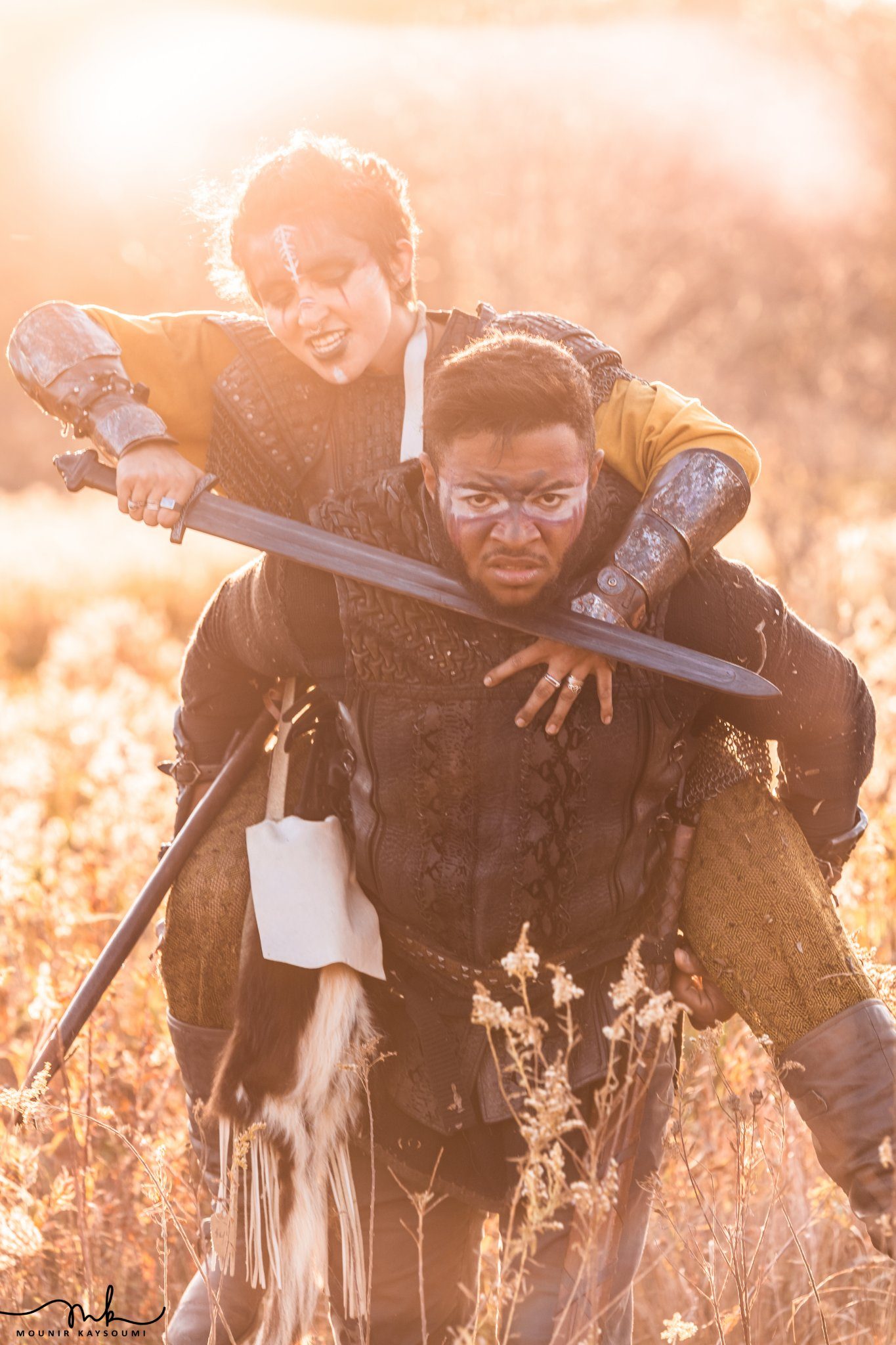 Warrior carrying a woman at sunset